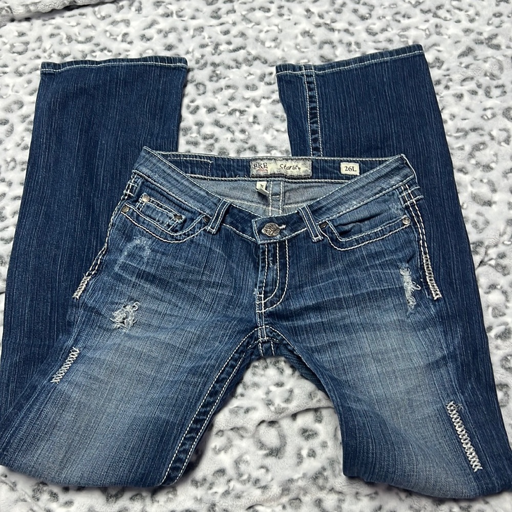 Buckle distressed denim bootcut jeans